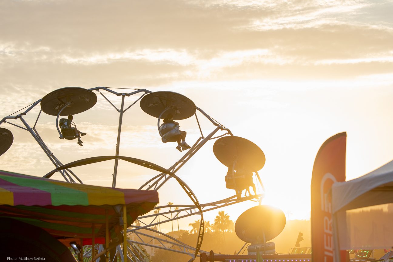 Swing ride silhouetted against a golden Malibu sunset at the Cook-Off